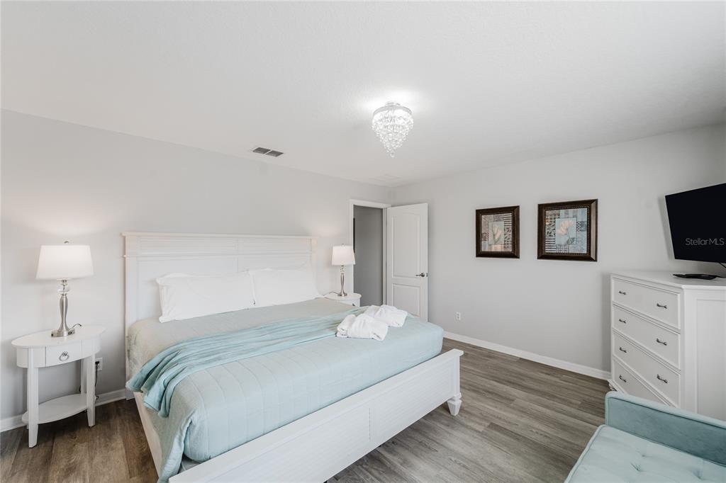 8961 Majesty Palm Road Kissimmee, FL 34747 - Photo 22 of 40 a bedroom with a bed and a flat screen tv