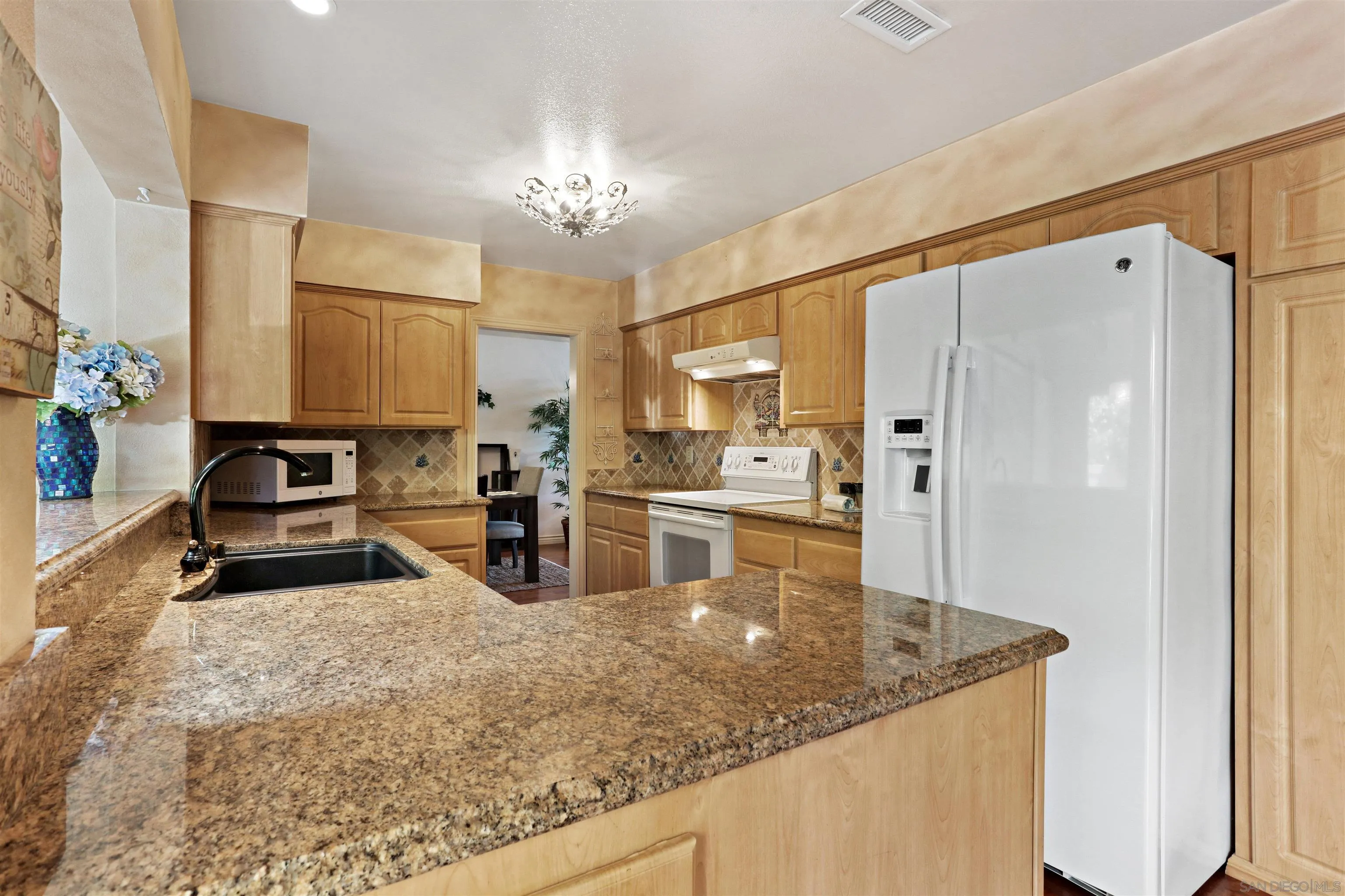 17062 Matinal Road San Diego, CA 92127 - Photo 13 of 42 a kitchen with stainless steel appliances granite countertop a sink refrigerator and cabinets