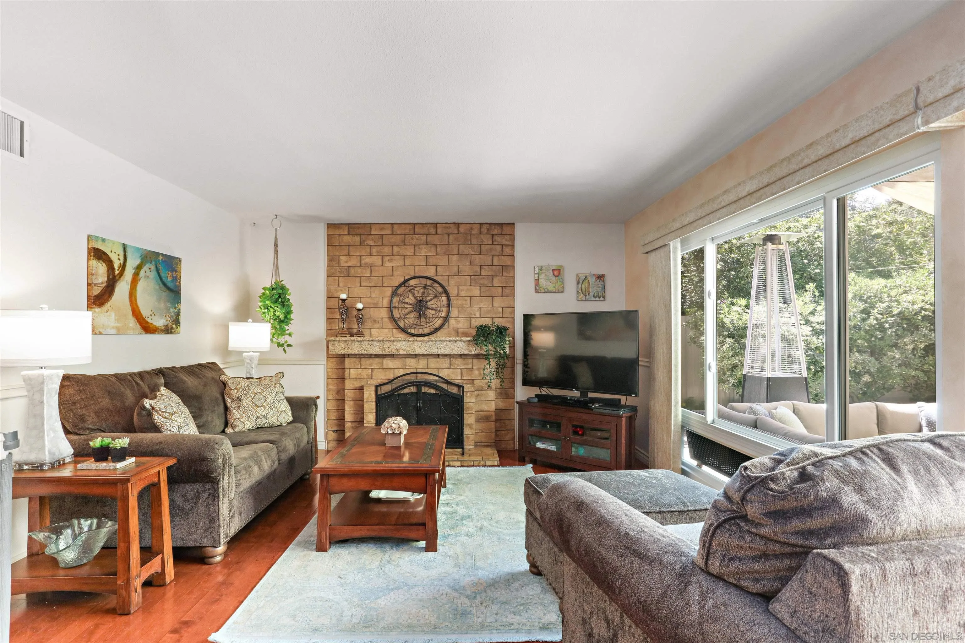 17062 Matinal Road San Diego, CA 92127 - Photo 16 of 42 a living room with furniture a flat screen tv and a fireplace