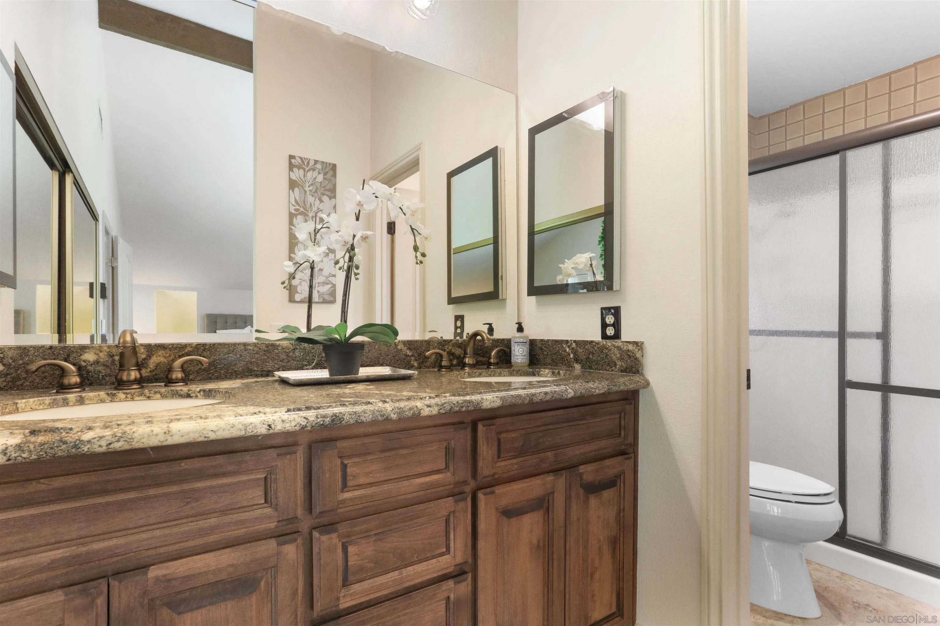17062 Matinal Road San Diego, CA 92127 - Photo 27 of 42 a bathroom with a granite countertop sink mirror vanity and toilet