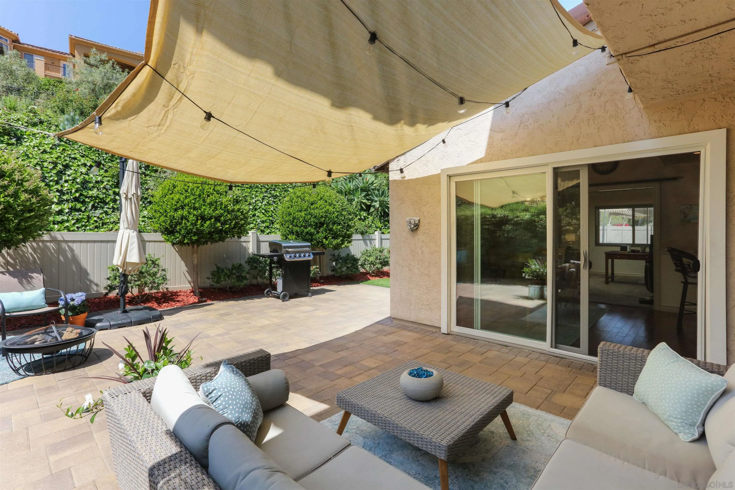 17062 Matinal Road San Diego, CA 92127 - Photo 33 of 42 a view of a patio with couches table and chairs under an umbrella