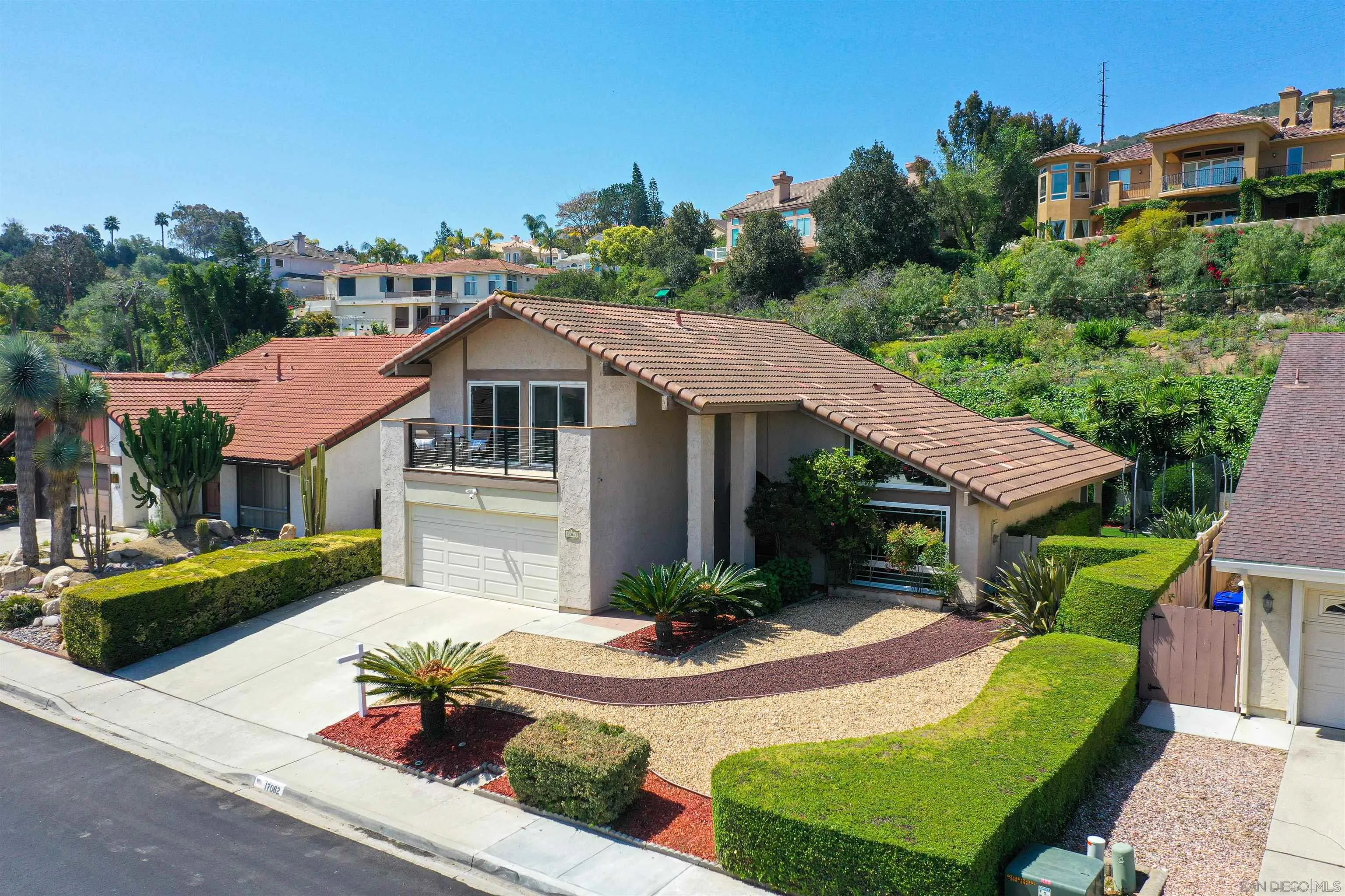 17062 Matinal Road San Diego, CA 92127 - Photo 5 of 42 a front view of a house with garden