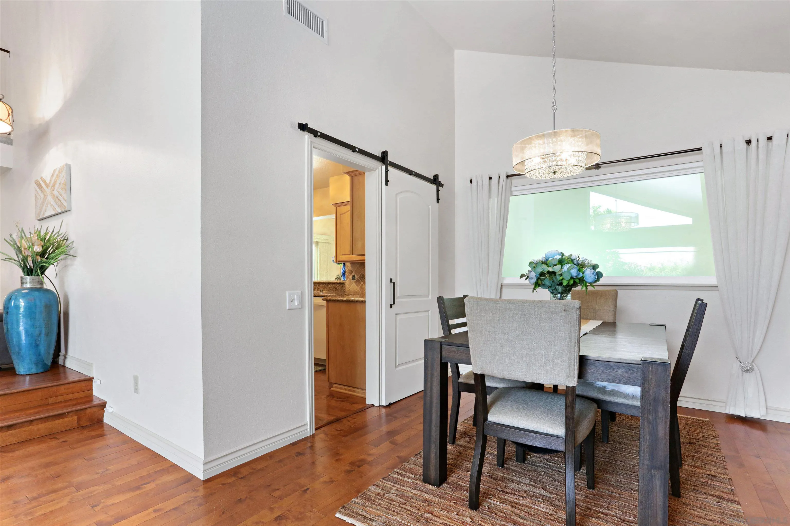 17062 Matinal Road San Diego, CA 92127 - Photo 10 of 42 a view of a dining room with furniture window and wooden floor