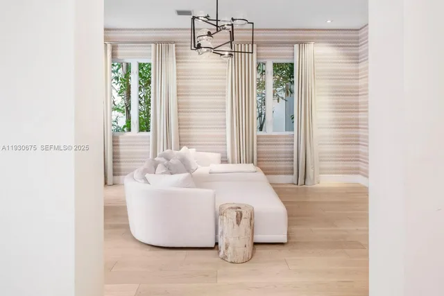 a white bath tub sitting in a bathroom next to a window