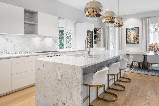 a view of kitchen island dining table and wooden floor