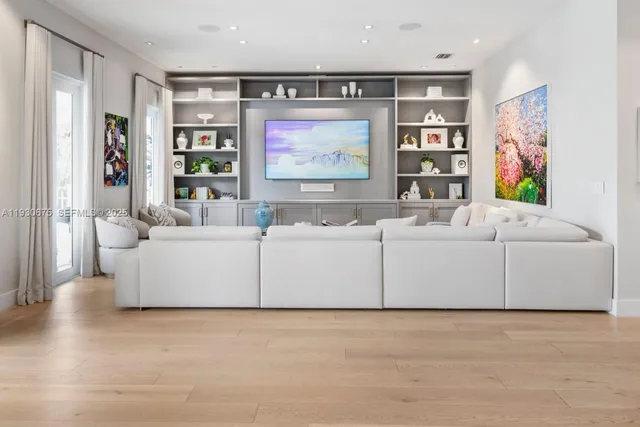 a living room with furniture and a flat screen tv