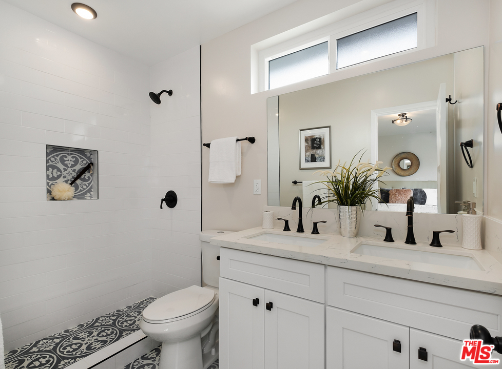 13927 Studebaker Road Norwalk, CA 90650 - Photo 15 of 27 a bathroom with a toilet sink and mirror