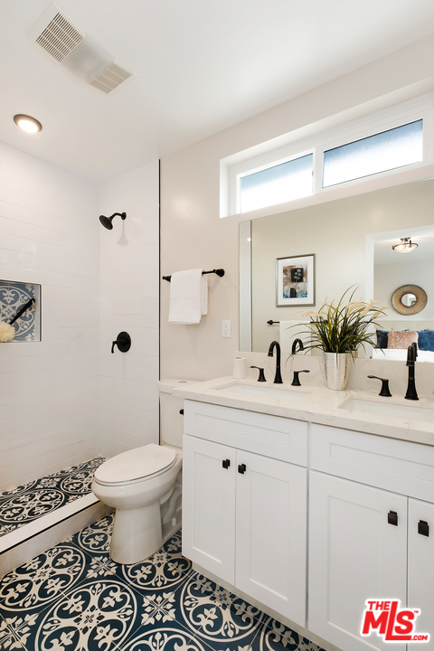13927 Studebaker Road Norwalk, CA 90650 - Photo 16 of 27 a bathroom with a sink toilet and shower