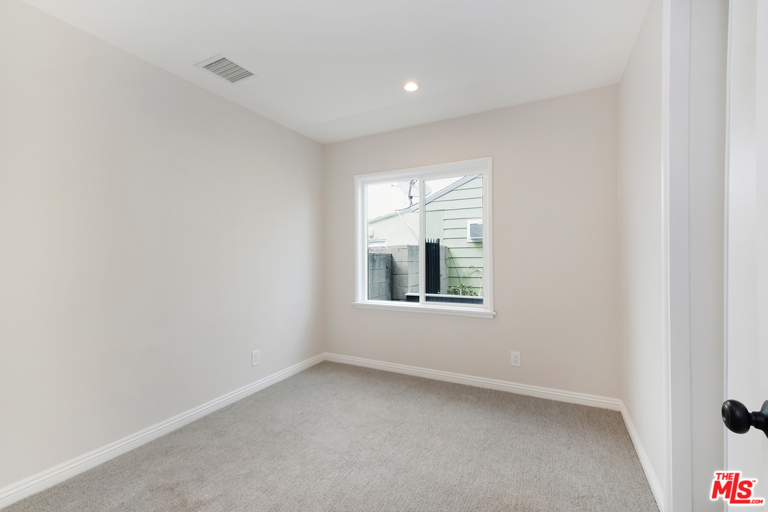 13927 Studebaker Road Norwalk, CA 90650 - Photo 17 of 27 a view of an empty room with a window