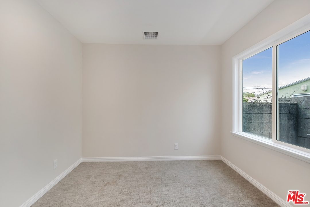 13927 Studebaker Road Norwalk, CA 90650 - Photo 18 of 27 an empty room with a window