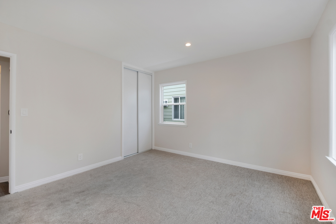 13927 Studebaker Road Norwalk, CA 90650 - Photo 19 of 27 a view of an empty room with a window