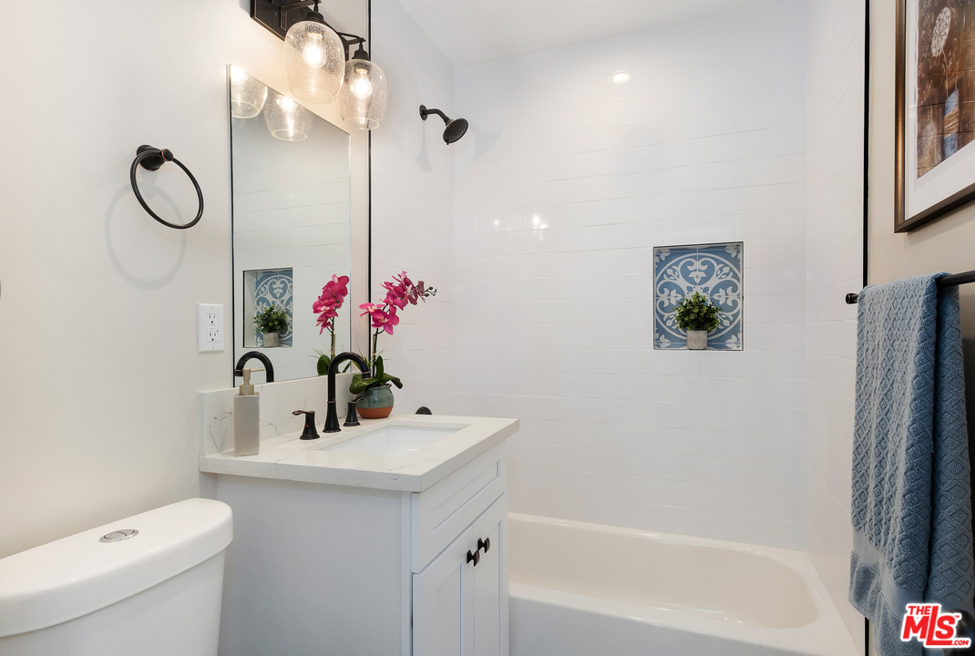 13927 Studebaker Road Norwalk, CA 90650 - Photo 20 of 27 a bathroom with a sink and a mirror