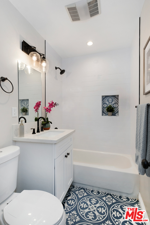 13927 Studebaker Road Norwalk, CA 90650 - Photo 21 of 27 a bathroom with a sink mirror toilet and bathtub