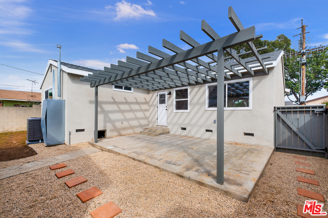 13927 Studebaker Road Norwalk, CA 90650 - Photo 22 of 27 a view of a house with a patio