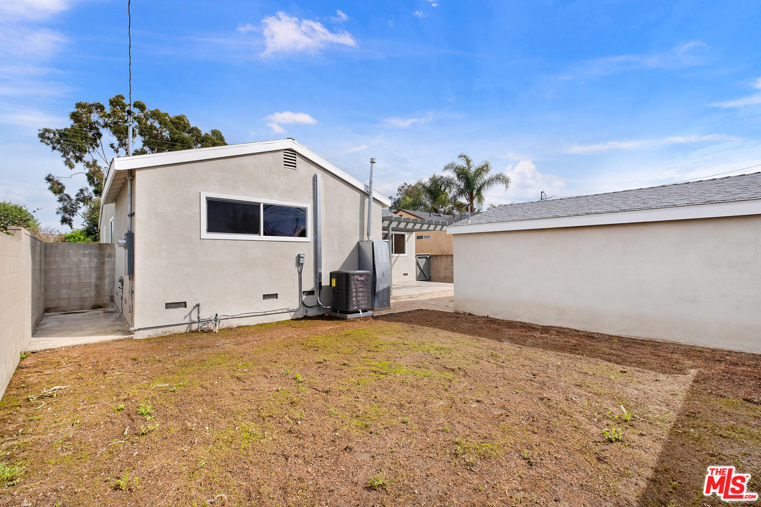 13927 Studebaker Road Norwalk, CA 90650 - Photo 24 of 27 a view of a house with a garage