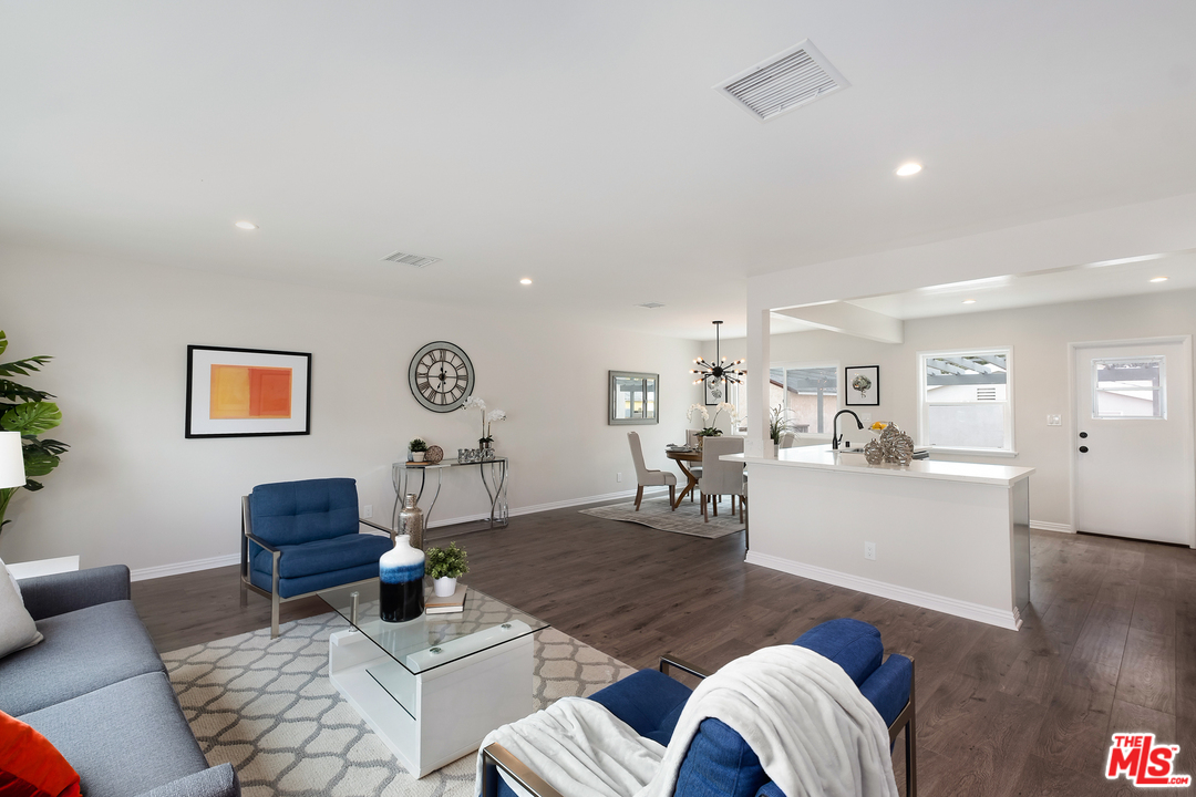 13927 Studebaker Road Norwalk, CA 90650 - Photo 4 of 27 a living room with furniture and a wooden floor