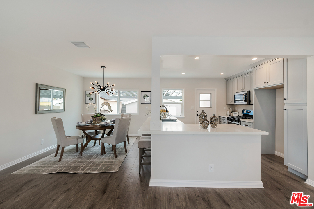 13927 Studebaker Road Norwalk, CA 90650 - Photo 6 of 27 a view of a dining room with furniture and wooden floor