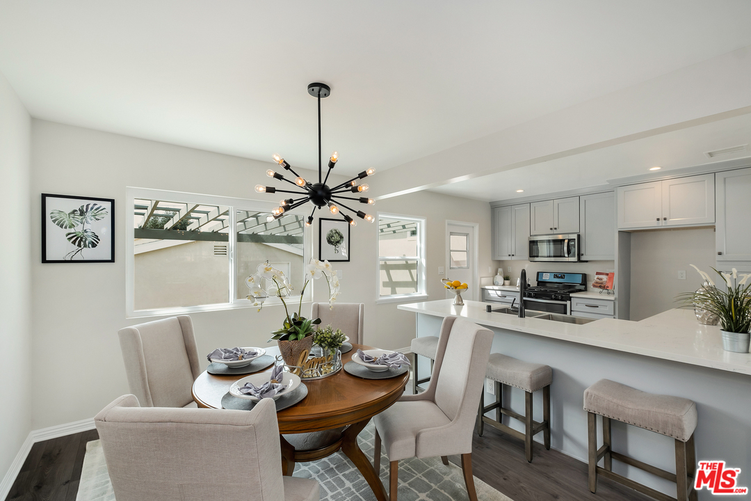 13927 Studebaker Road Norwalk, CA 90650 - Photo 7 of 27 a living room with furniture and kitchen view
