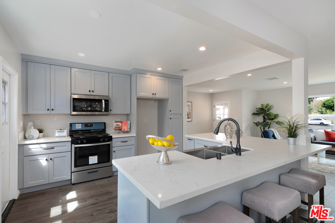 13927 Studebaker Road Norwalk, CA 90650 - Photo 8 of 27 a kitchen with stainless steel appliances a sink and a refrigerator