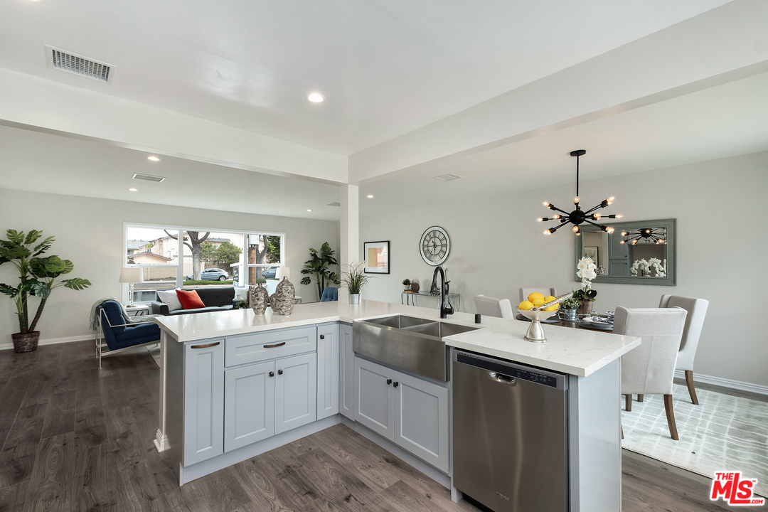 13927 Studebaker Road Norwalk, CA 90650 - Photo 10 of 27 a kitchen with a sink stove and cabinets