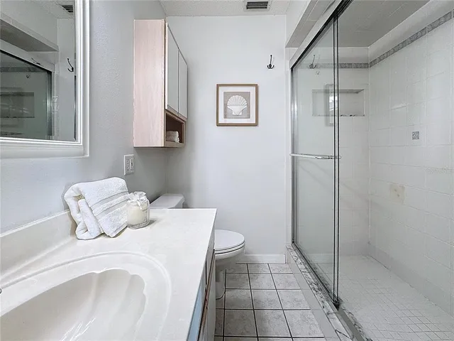 a bedroom with a bed and a mirror