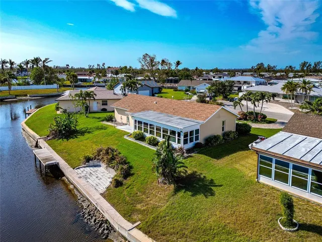 an aerial view of a house with yard swimming pool and outdoor seating