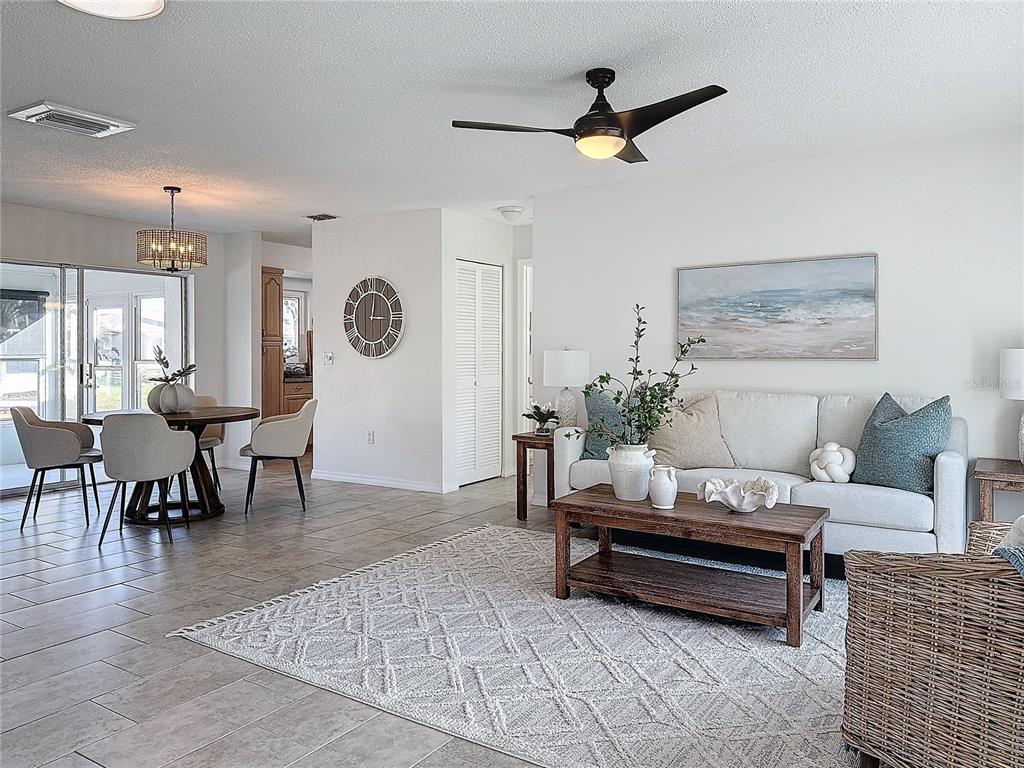 5011 Mangrove Point Road Bradenton, FL 34210 - Photo 2 of 49 a living room with furniture and a table