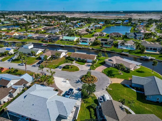 an aerial view of a houses with a swimming pool