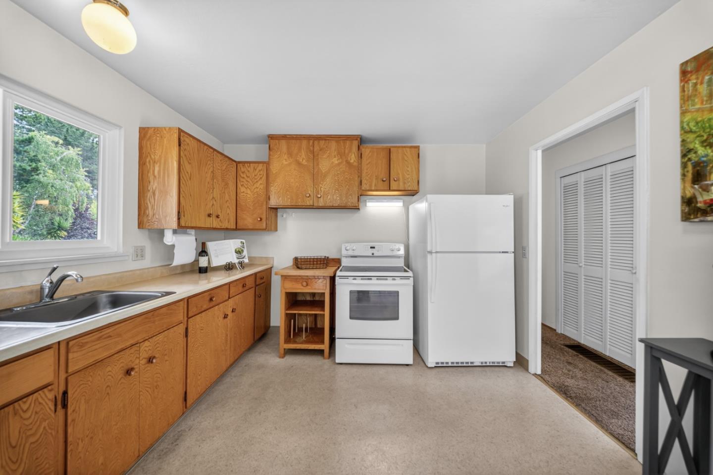 1287 Lerida Way Pacifica, CA 94044 - Photo 25 of 52 a kitchen with white cabinets and white appliances