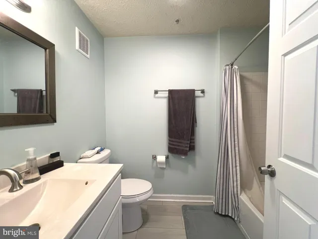 a bathroom with a toilet a sink and shower