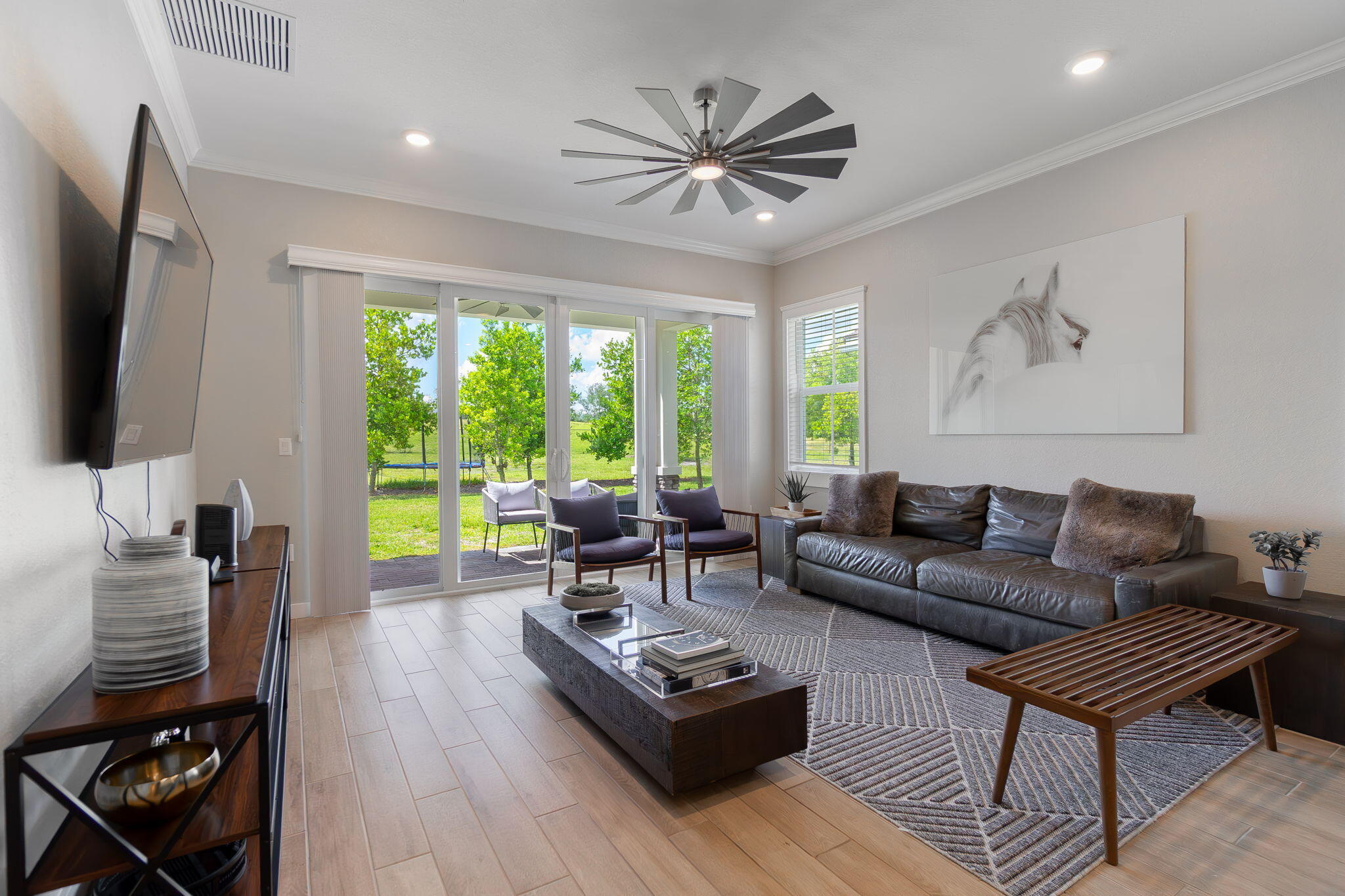 19546 Weathervane Way Loxahatchee, FL 33470 - Photo 20 of 63 a living room with furniture a large window and a flat screen tv