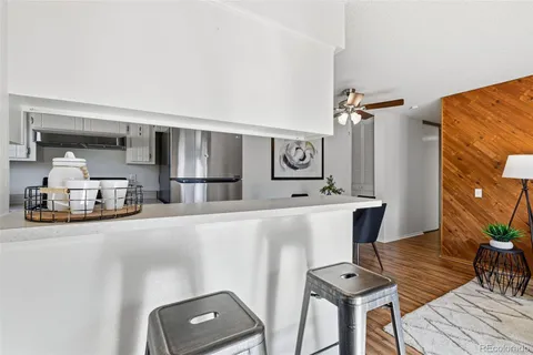 a view of a kitchen with furniture and wooden floor