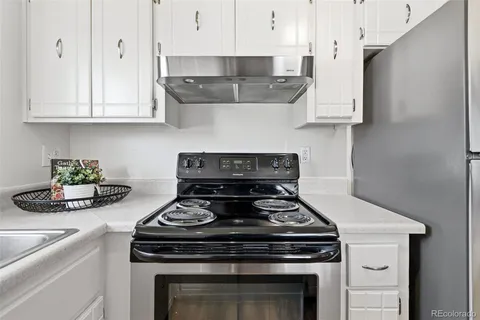a stove top oven sitting inside of a kitchen