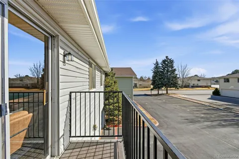 a view of balcony with wooden floor and fence