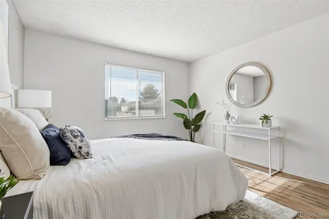 a bedroom with a large bed and a window