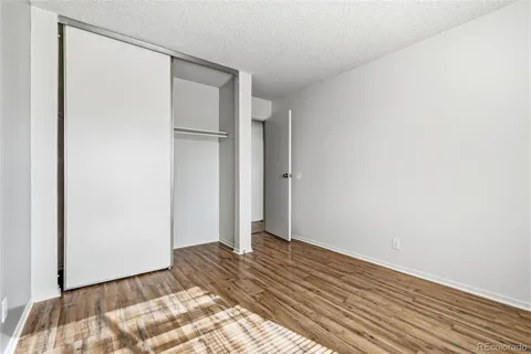 a view of bedroom with wooden floor