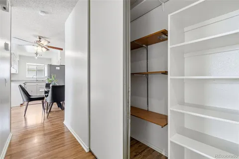 a view of a room with wooden floor and furniture