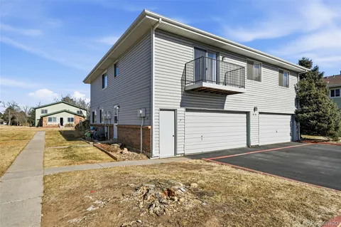 a view of a house with snow on the road