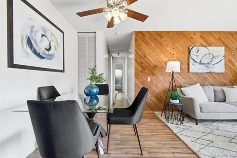 a dining room with furniture and wooden floor