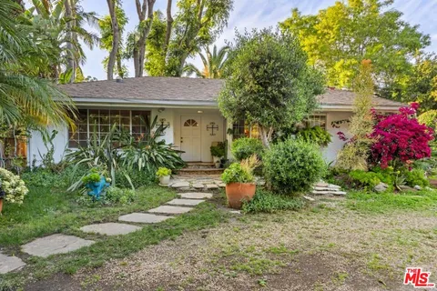 a view of a house with potted plants