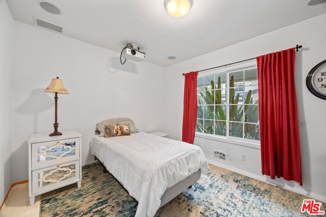14949 Valley Vista Boulevard Sherman Oaks, CA 91403 - Photo 6 of 9 a bedroom with bed and window
