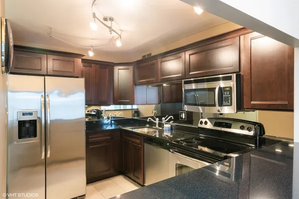 a kitchen with a sink stainless steel appliances and counter space