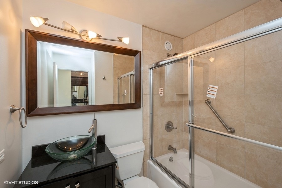 211 East Ohio Street, Unit 2012 Chicago, IL 60611 - Photo 9 of 19 a bathroom with a sink and a mirror