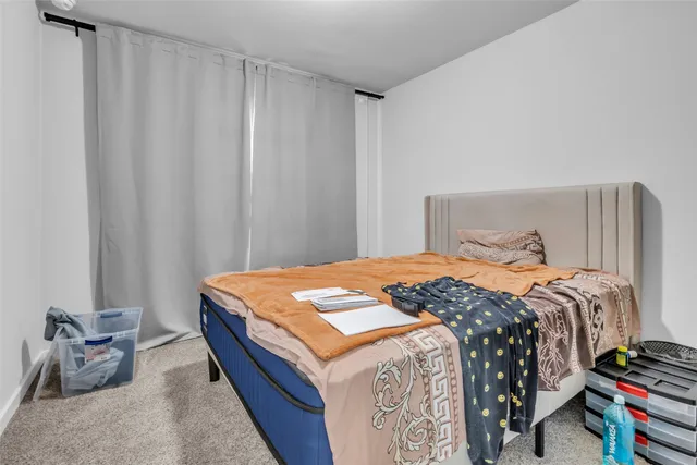 a bedroom with a bed and a chair