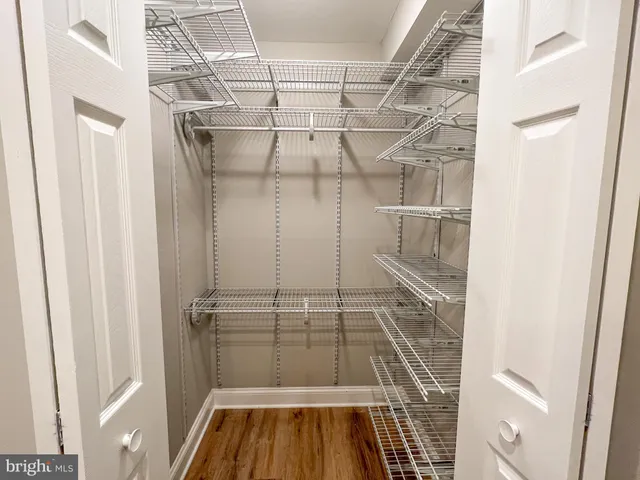 a view of walk in closet with empty racks