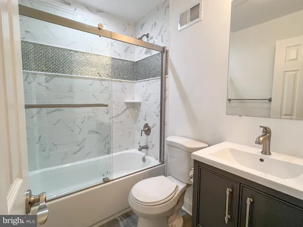 a bathroom with a sink a toilet and a bathtub