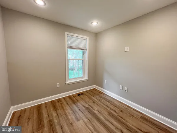 a view of room with window and wooden floor