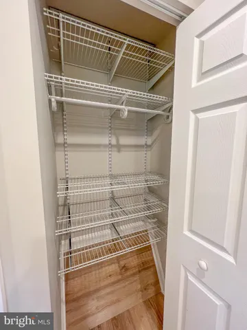 a view of walk in closet with empty racks