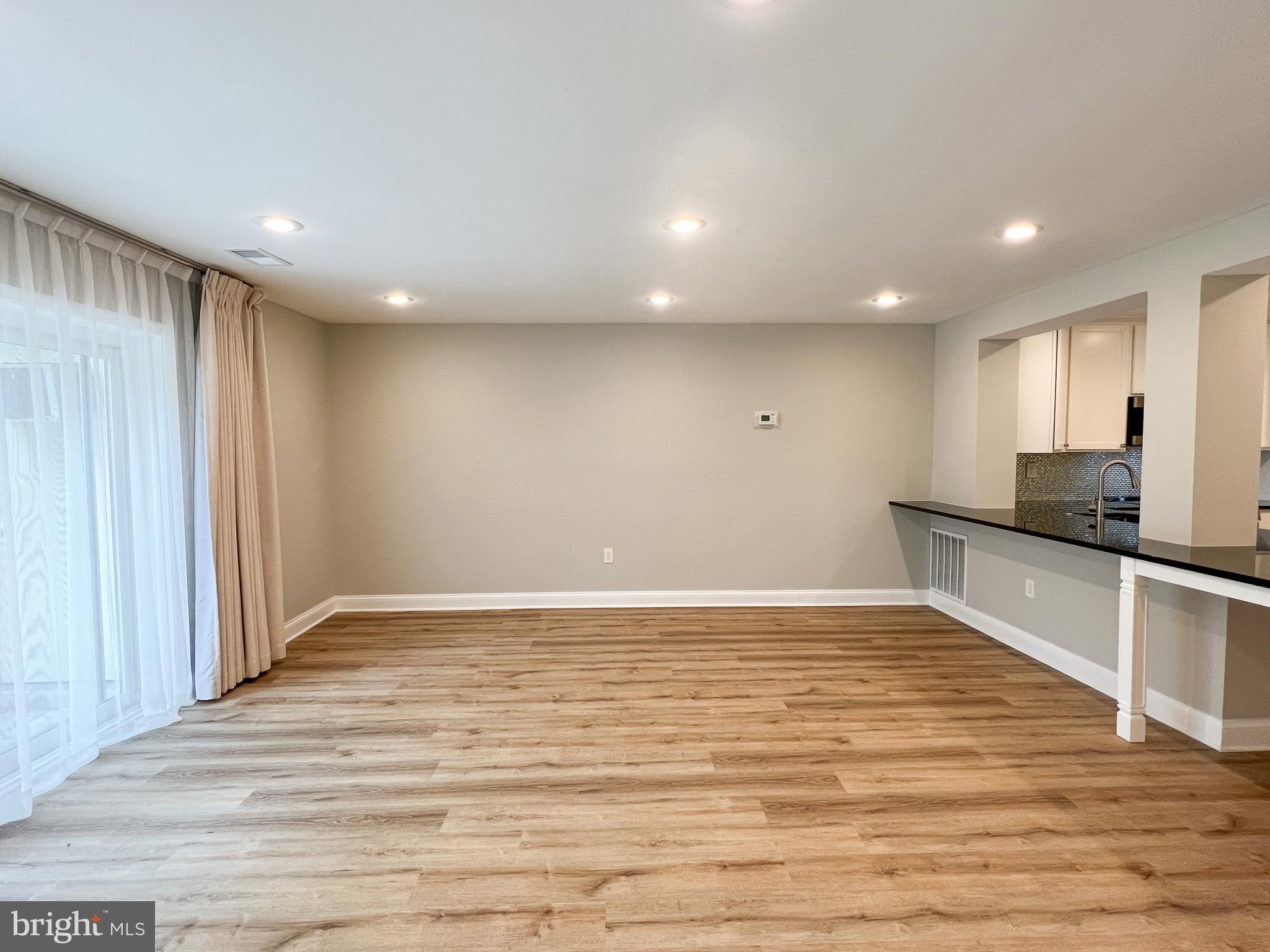 36 Pennydog Court Silver Spring, MD 20902 - Photo 16 of 27 a view of an empty room with wooden floor and a window