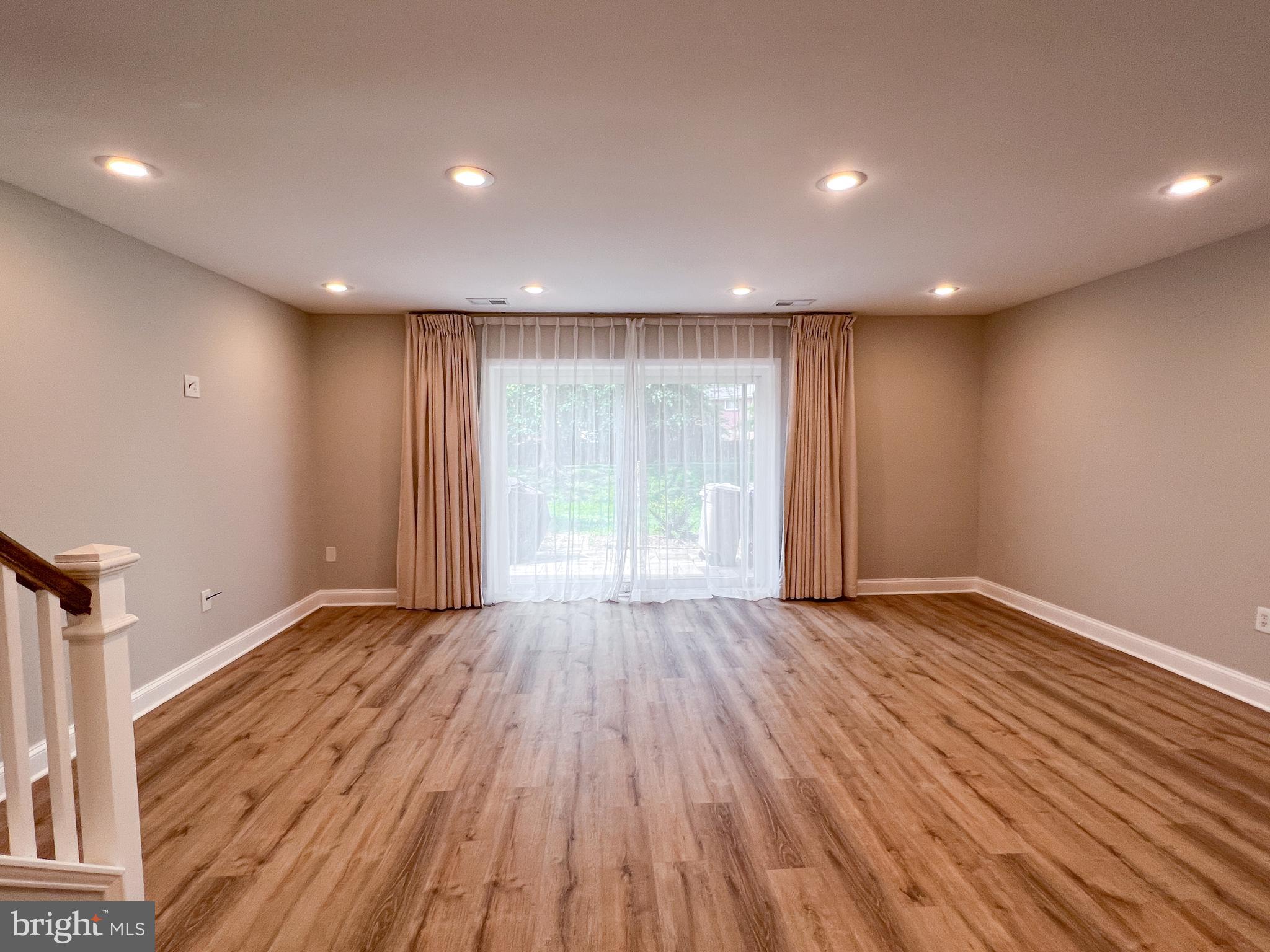 36 Pennydog Court Silver Spring, MD 20902 - Photo 17 of 27 a view of an empty room with wooden floor and a window